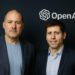 Jony Ive and Sam Altman stand side by side in front of the OpenAI logo, marking a $6.5B collaboration on a new AI hardware device.